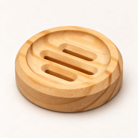 Circle SoapCouch pine soap dish with three recessed grooves on a warm neutral surface