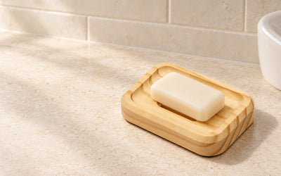 Rectangle SoapCouch pine soap dish holding an ivory soap bar beside a bathroom basin