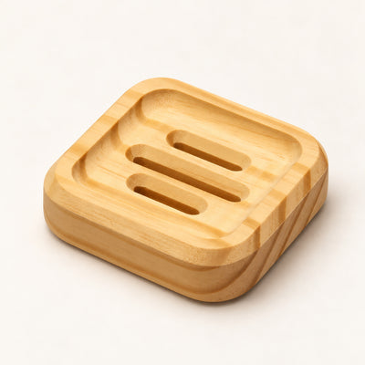 Square SoapCouch pine soap dish with three recessed grooves on a warm neutral surface
